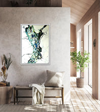 Load image into Gallery viewer, A framed abstract painting hangs on a textured taupe dividing wall in a modern sitting room.
