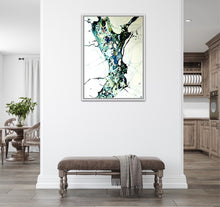 Load image into Gallery viewer, A framed abstract painting hangs on a white dividing wall in a modern room setting.
