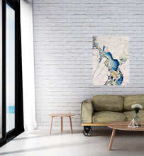 Load image into Gallery viewer, Abstract painting in shades of blue and oyster white with small multicoloured pieces. In situ on a white brick wall.
