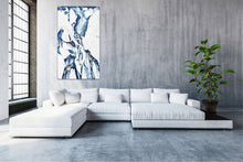 Load image into Gallery viewer, Abstract oil painting on a white background in light blue, mid blue and aqua with multicoloured detail, shown on a living room wall.
