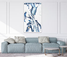 Load image into Gallery viewer, Abstract oil painting on a white background in light blue, mid blue and aqua with multicoloured detail, on a living room wall.
