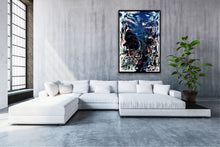 Load image into Gallery viewer, Abstract oil and mixed medium painting in shades of dark blue, royal blue and multicoloured detail on living room wall.
