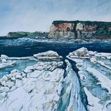 Load image into Gallery viewer, Coastal scene looking towards Werri Beach NSW, with a white rock platform, ocean swell and waves in the foreground, red cliffs in the background and a grassy headland with pine trees in the distance. Close up view.
