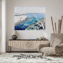 Load image into Gallery viewer, Abstract painting showing a headland jutting out into the ocean, in shades of blue and white. In situ on a taupe wall.
