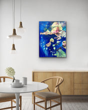 Load image into Gallery viewer, Abstract oil painting, mixed media on canvas. Royal blue with shades of green, pink and yellow. Shown in situ in a dining room on a white wall. 
